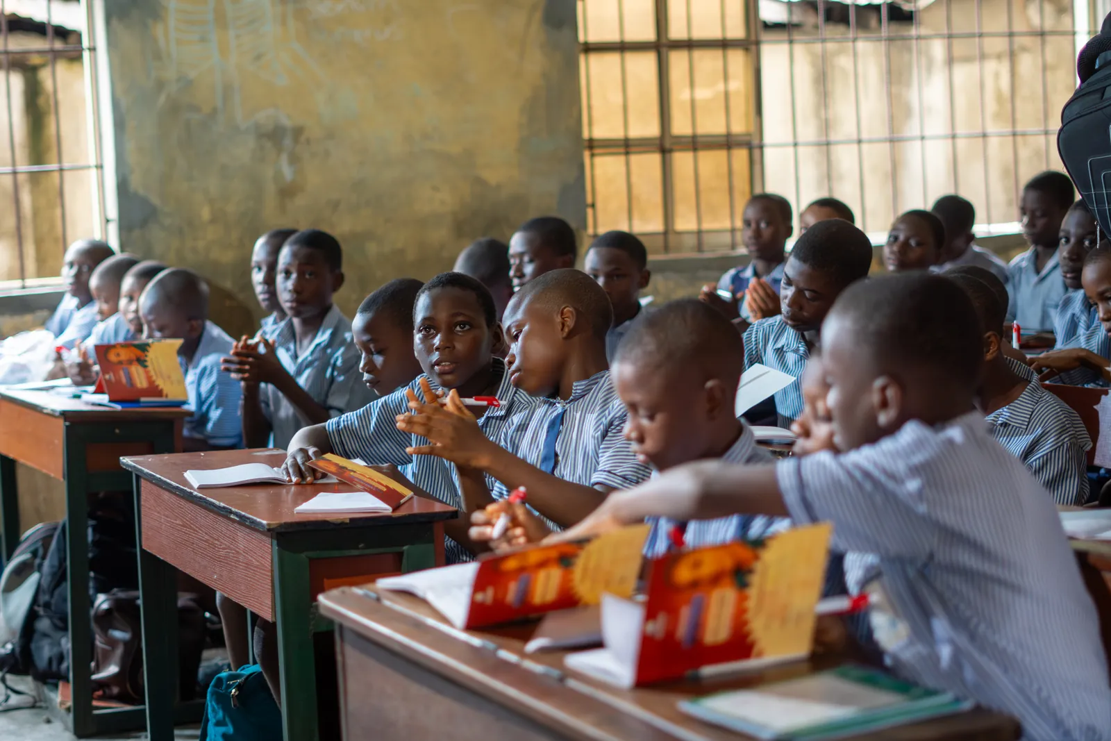 Students seated at desks with learning materials