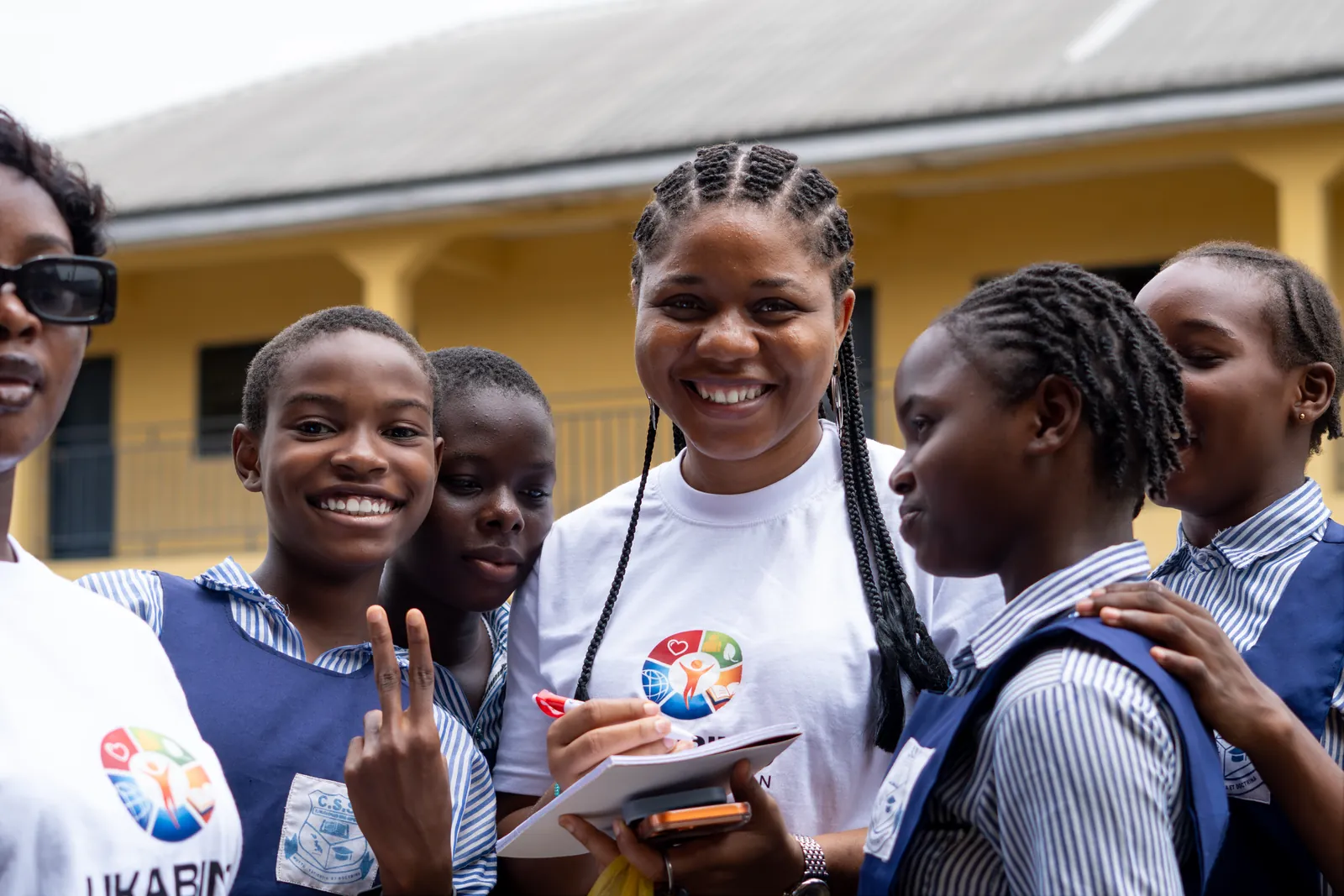 The founder smiling with students