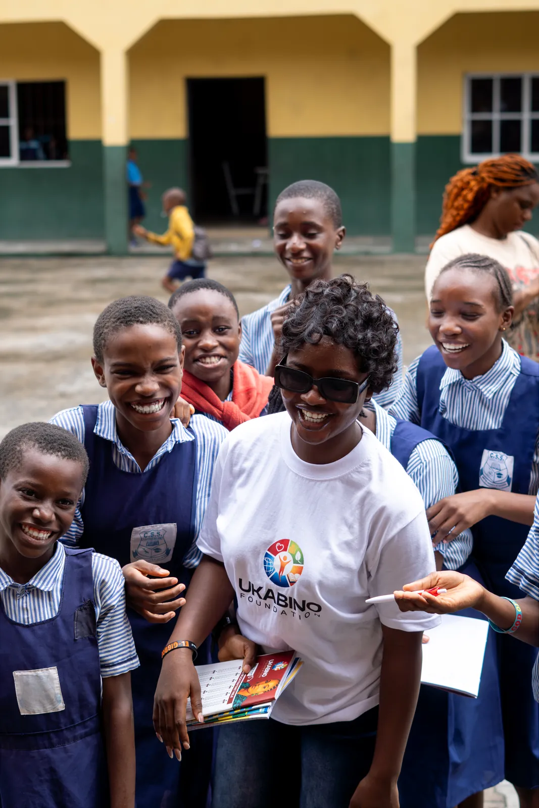 A volunteer and students smiling together
